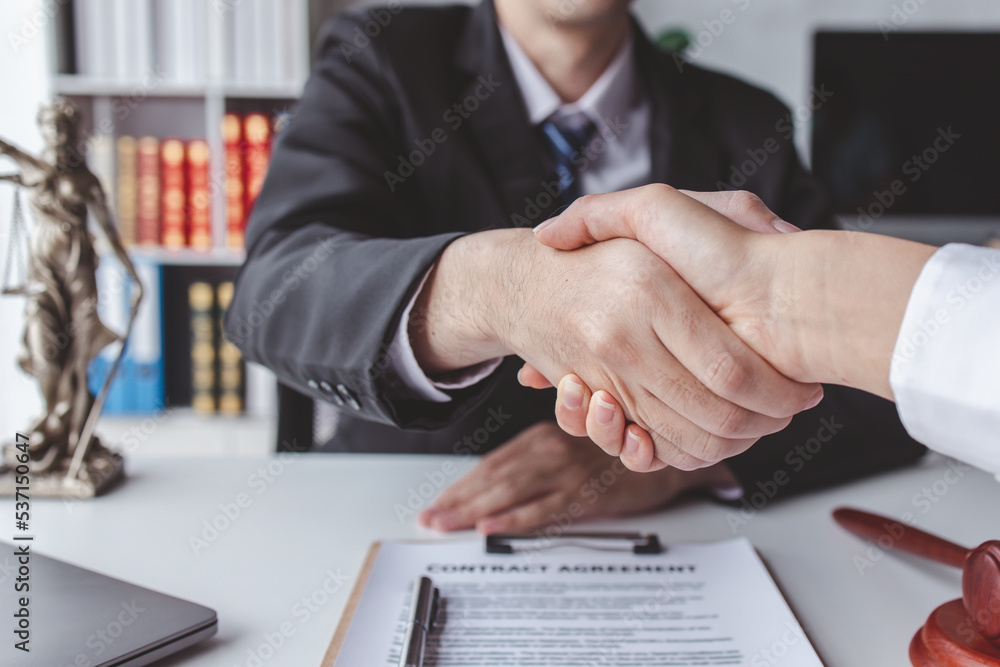 justice and law concept. male lawyer working in workplace. Legal law, advice and justice, Businessman handshake with a lawyer or judge After signing the contract and the agreement is complete, 