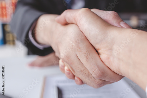 justice and law concept. male lawyer working in workplace. Legal law, advice and justice, Businessman handshake with a lawyer or judge After signing the contract and the agreement is complete,  © David