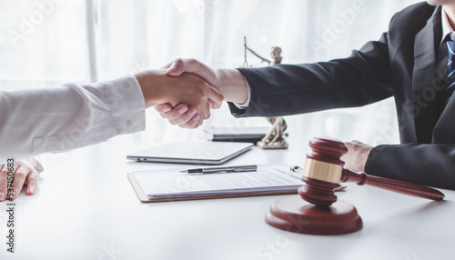 justice and law concept. male lawyer working in workplace. Legal law, advice and justice, Businessman handshake with a lawyer or judge After signing the contract and the agreement is complete, 