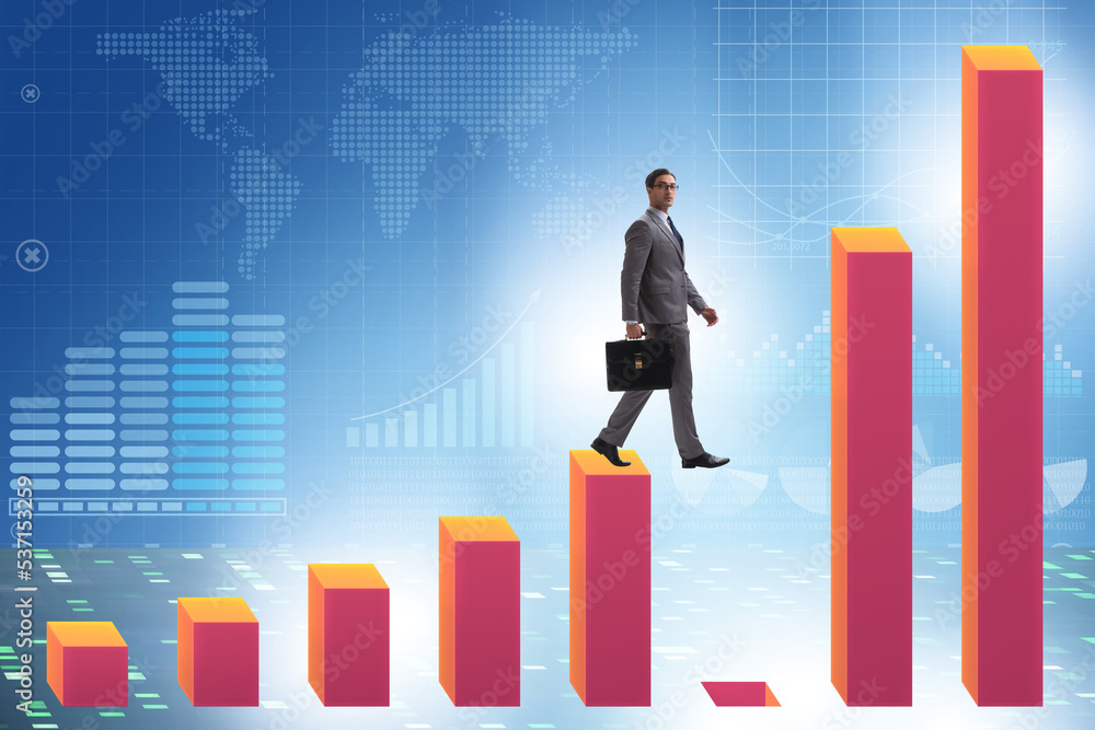 Businessman in growth concept with bar charts Businessman in growth concept with bar charts