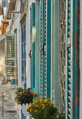 Wooden windows and shutters painted blue in house at sunset