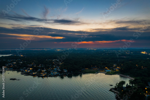 Aerial view at Branford Point in Branford  CT with New Haven  CT in the background during sunset