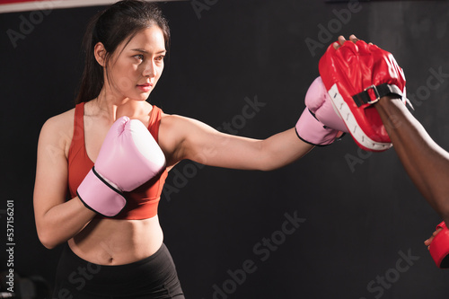 Asia woman training kick of boxing in gym