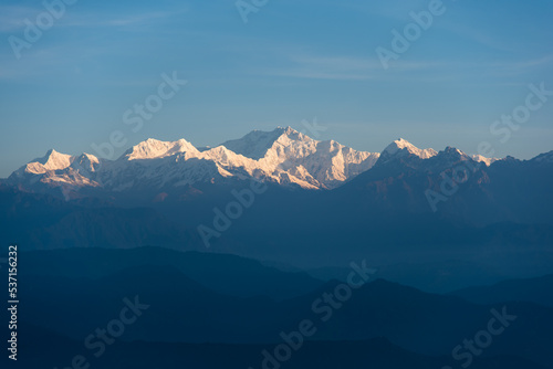 Snow capped mountain peaks in the morning light. Close up, selective focus. photo