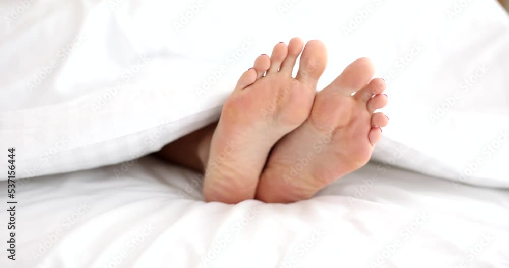 Closeup of female naked legs in bed Closeup of female naked legs in bed