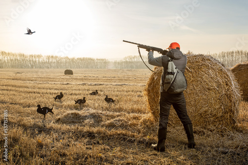 hunter shooting to the flying bird.