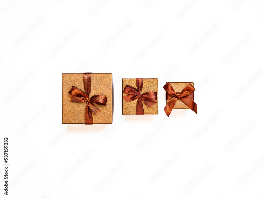 three golden gift boxes isolated on white background three golden gift boxes isolated on white background