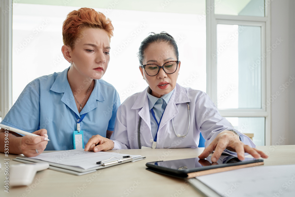 Doctor with nurse using tablet pc Doctor with nurse using tablet pc