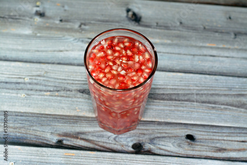 The pomegranate (Punica granatum), a fruit-bearing deciduous shrub in the family Lythraceae, subfamily Punicoideae contains clusters of seeds with sarcotesta on the inside, selective focus photo