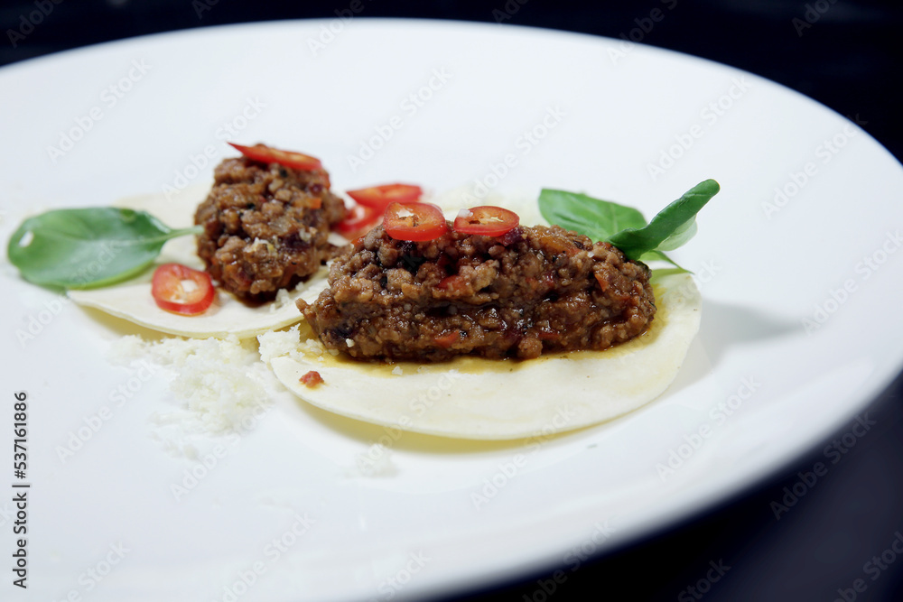 Minced cooked meat on croutons