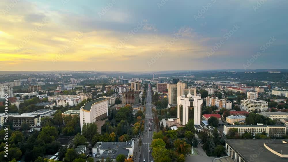 Aerial drone view of Chisinau at sunset, Moldova. View of city centre with presidency and parliament, multiple buildings, roads, lush greenery, cityscape