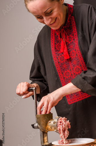 Preparation of minced meat in a meat grinder photo