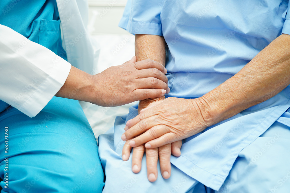 Doctor taking care, help and encourage Asian elder senior woman patient in clinic hospital. Doctor taking care, help and encourage Asian elder senior woman patient in clinic hospital.