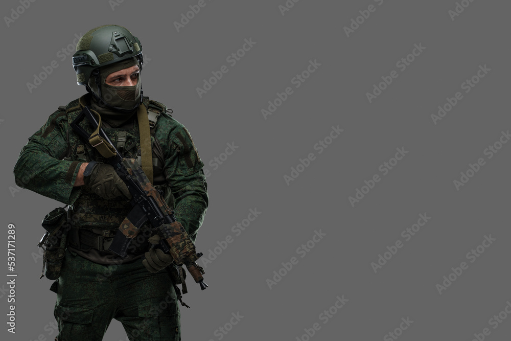 Portrait of military russian man with rifle dressed in modern camouflage uniform. Portrait of military russian man with rifle dressed in modern camouflage uniform.