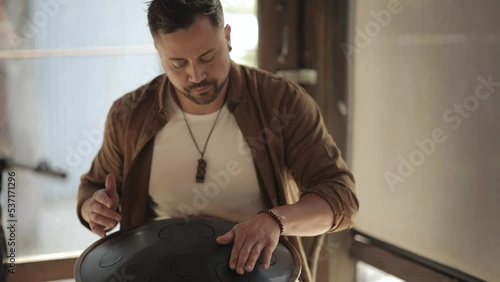 Yong Man Playing Handpan Shaman during Sound Healing Ceremony Slow Motion Musician Performing