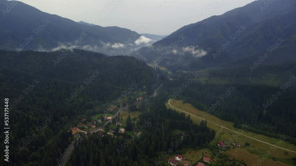 Birdseye view of a scenic forest near modern public infrastructure in Predeal, Brasov county, Romania. Autumn rainy day, evening footage Birdseye view of a scenic forest near modern public infrastructure in Predeal, Brasov county, Romania. Autumn rainy day, evening footage