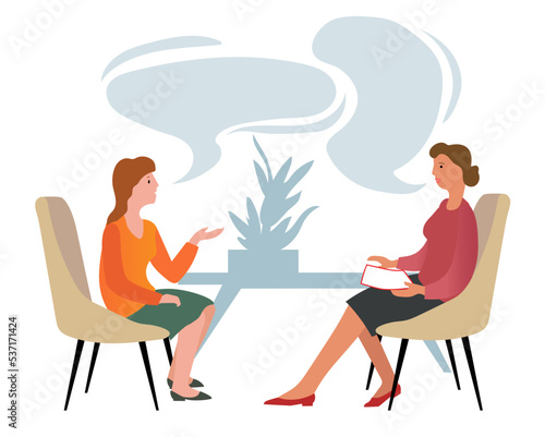 Two women sit on the armchairs and talk about something. Psychotherapist has a session with her patient. Business interview and Conversation concept.