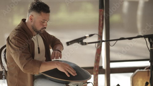 Yong Man Playing Handpan Shaman during Sound Healing Ceremony Slow Motion Musician Performing