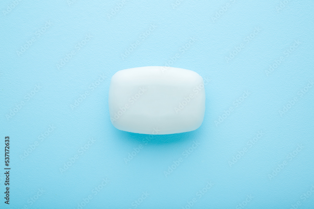 New hand soap on light blue table background. Pastel color. Care about clean and soft body skin. Daily beauty product. Closeup. Top down view. New hand soap on light blue table background. Pastel color. Care about clean and soft body skin. Daily beauty product. Closeup. Top down view.