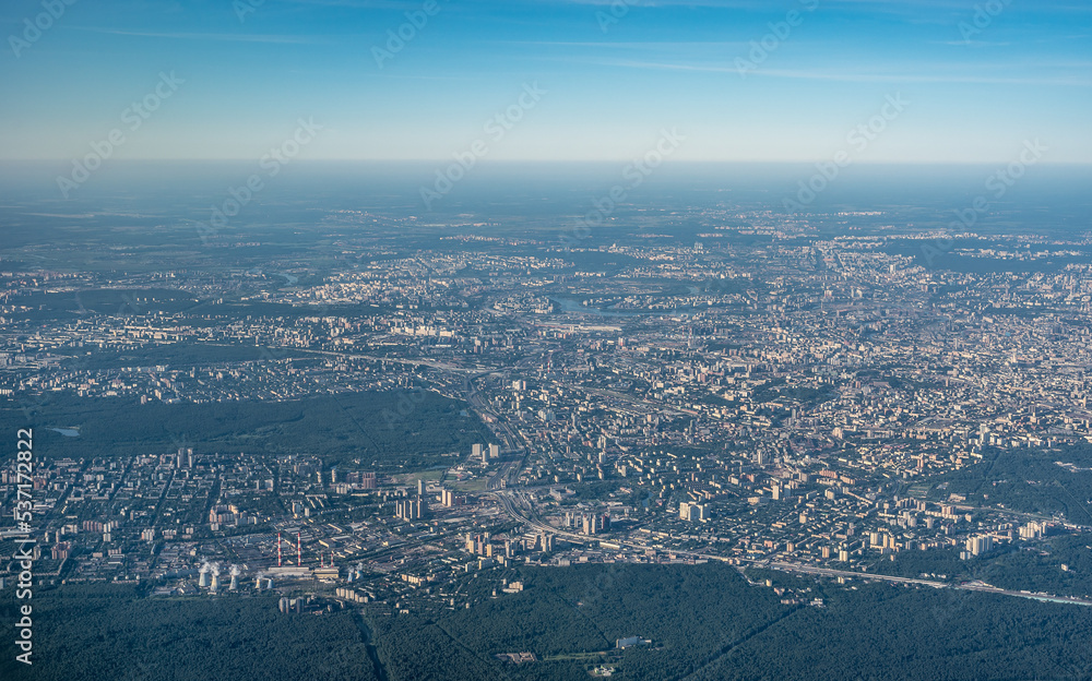 Aerial view photo from airplane of city and clear sky. aerial photo of large city from an airplane window. view of city through window from plane