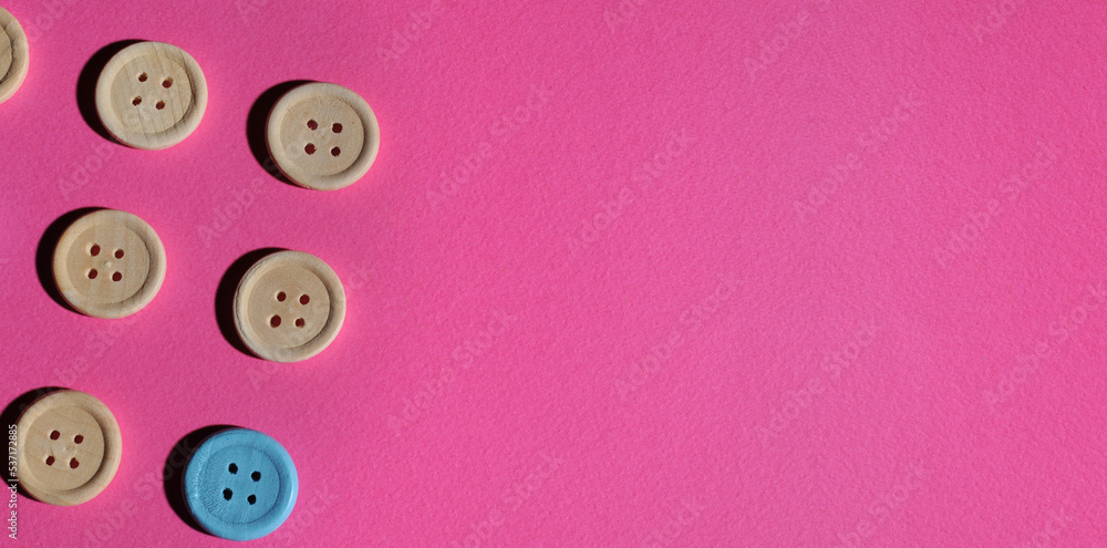 The concept of wooden buttons on a pink background ... 