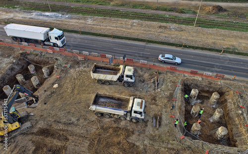 Aerial view of large construction site with several earthmover machines