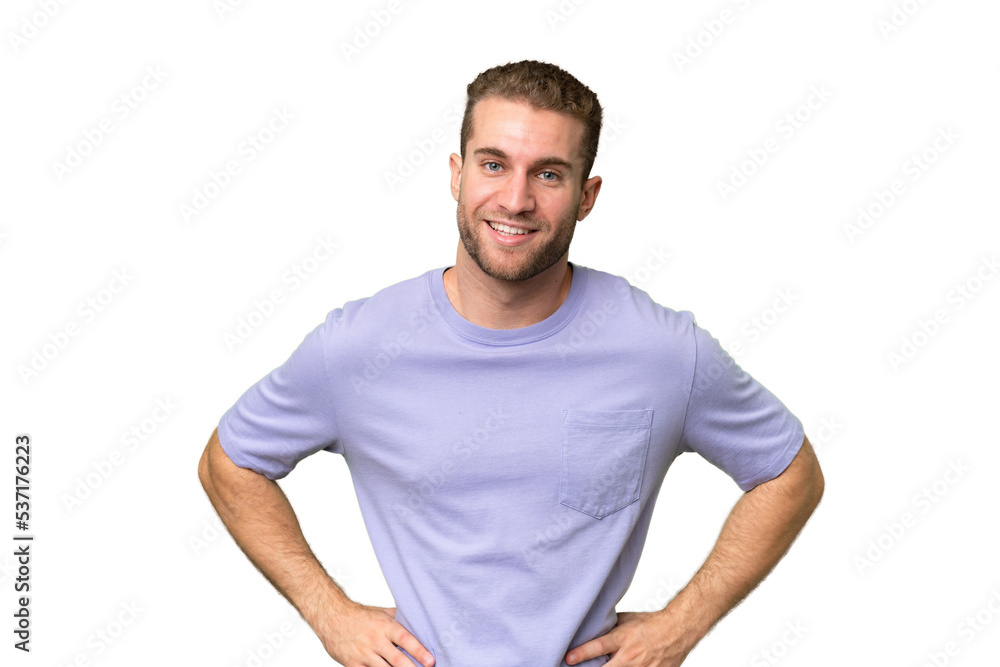 Young handsome caucasian man isolated on green chroma background posing with arms at hip and smiling Young handsome caucasian man isolated on green chroma background posing with arms at hip and smiling