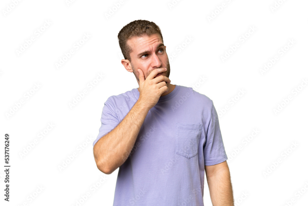 Young handsome caucasian man isolated on green chroma background having doubts and with confuse face expression Young handsome caucasian man isolated on green chroma background having doubts and with confuse face expression