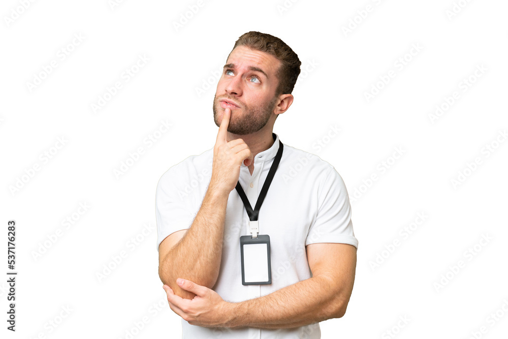 Young caucasian man with ID card isolated on green chroma background having doubts while looking up Young caucasian man with ID card isolated on green chroma background having doubts while looking up