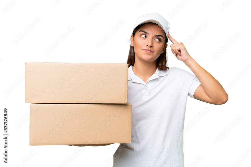 Delivery caucasian woman holding boxes isolated on green chroma background having doubts and thinking Delivery caucasian woman holding boxes isolated on green chroma background having doubts and thinking
