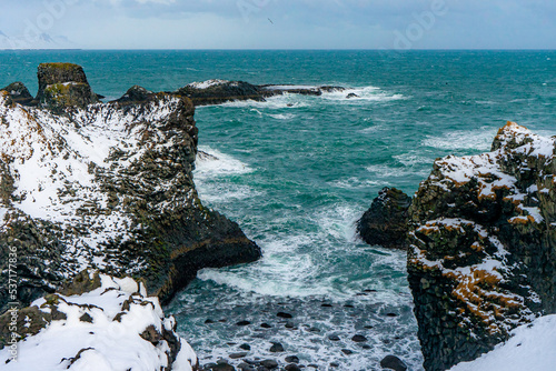 Gatklettur natural rock formation in the ocean at Arnarstapi , during winter everning in Arnarstapi , Snæfellsnes peninsula in Iceland : 15 March 2020 photo