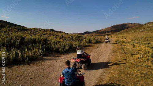 Aerial View From Behind ATVs by Lake and Mountain