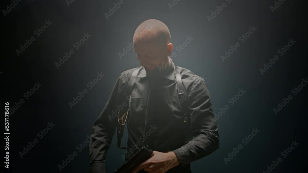 Police detective cop couldn't get the service pistol out of the holster. Failure. Gun was stuck in holster. Funny moment. Portrait of FBI agent. Law enforcement officer. Justice. Dark room with smoke Police detective cop couldn't get the service pistol out of the holster. Failure. Gun was stuck in holster. Funny moment. Portrait of FBI agent. Law enforcement officer. Justice. Dark room with smoke