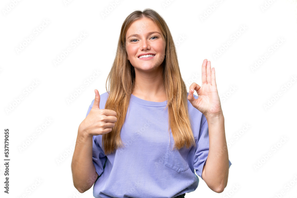 Young beautiful woman over isolated background showing ok sign and thumb up gesture Young beautiful woman over isolated background showing ok sign and thumb up gesture