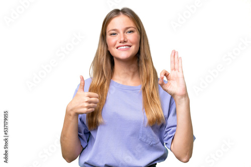 Young beautiful woman over isolated background showing ok sign and thumb up gesture
