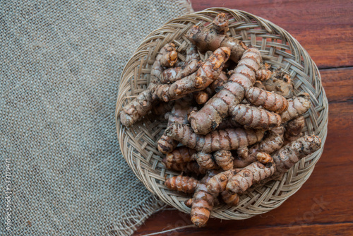 Traditional herbal ingredients of empon empon or root plants that are good for health and treatment in a bamboo basket, including turmeric, ginger, temulawak, galangal, wedang uwuh, and others photo