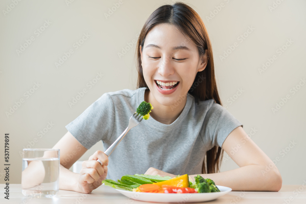 Diet, Dieting asian young woman or girl use fork at broccoli on mix vegetables, green salad bowl, eat food is low fat good health. Nutritionist female, Weight loss for healthy person. Diet, Dieting asian young woman or girl use fork at broccoli on mix vegetables, green salad bowl, eat food is low fat good health. Nutritionist female, Weight loss for healthy person.