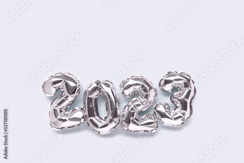 2023 silver balloons on a blue pastel background with copy space. Minimal festive concept.
