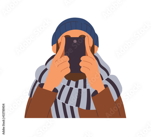 Man taking photo with mobile phone. Modern person hiding face behind smartpho...