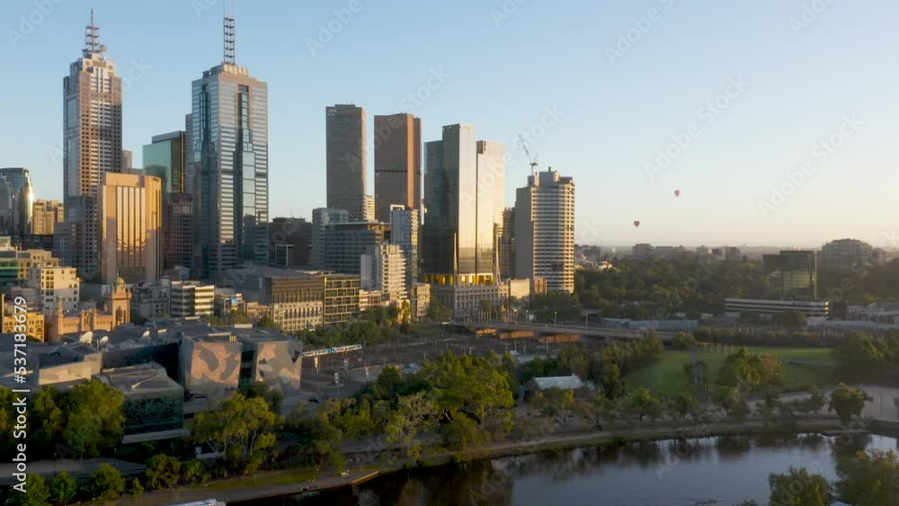 Balloons fly overhead with smooth pull back to reveal Melbourne CBD as train comes into dock at Flinders Street Station. Balloons fly overhead with smooth pull back to reveal Melbourne CBD as train comes into dock at Flinders Street Station.