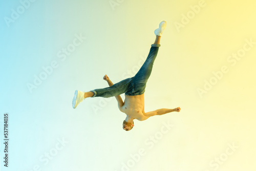 Flexible acrobat jumping upside down