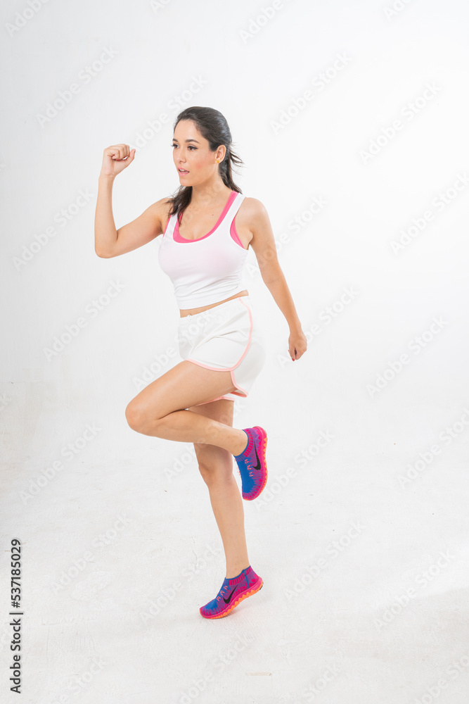 Studio portrait photo of a young beautiful elegant Brazilian female model lady wearing sports exercise running attire posing with a series moments of emotion and gesture Studio portrait photo of a young beautiful elegant Brazilian female model lady wearing sports exercise running attire posing with a series moments of emotion and gesture
