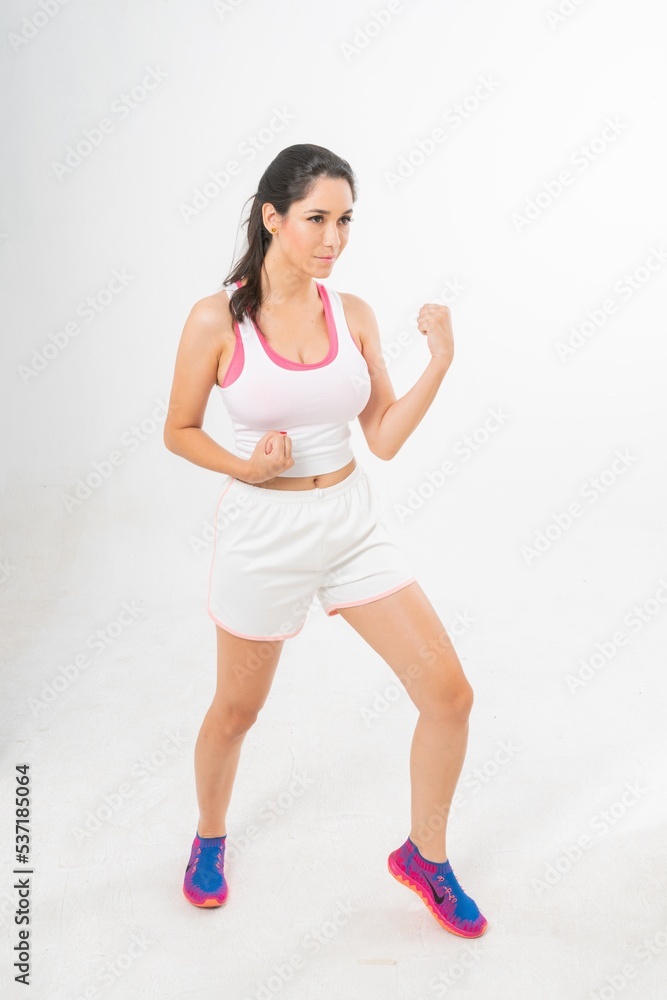 Studio portrait photo of a young beautiful elegant Brazilian female model lady wearing sports exercise running attire posing with a series moments of emotion and gesture 