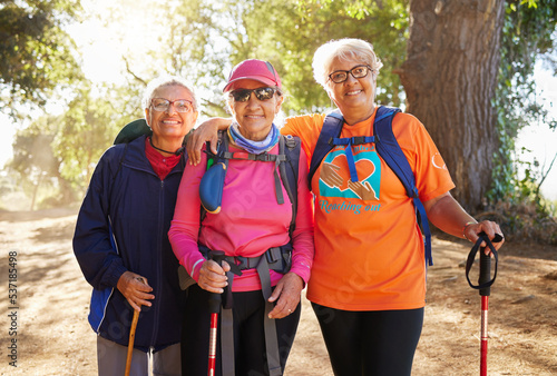 Senior women, hiking group and friends fitness in nature, park and forest for healthy lifestyle, wellness and freedom together. Portrait happy, elderly and retirement people walking exercise outdoors