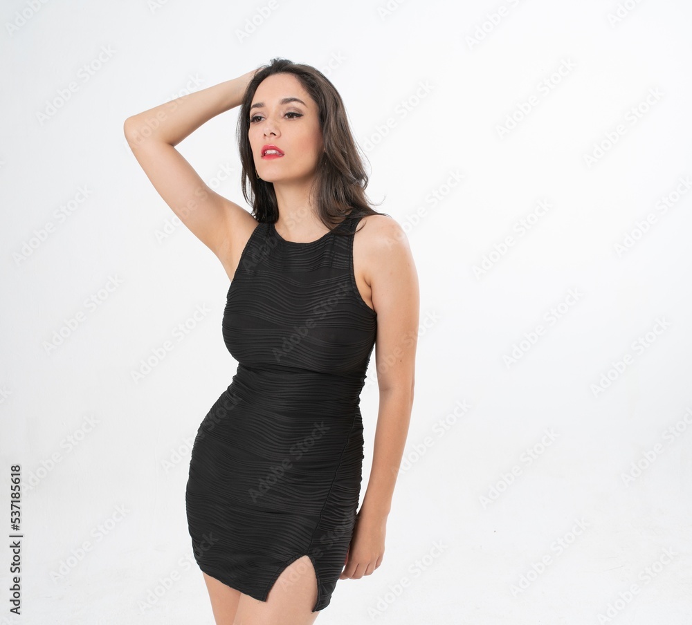 Studio portrait photo of a young beautiful elegant Brazilian female model lady wearing a black dining dress posing with a series moments of emotion and gesture Studio portrait photo of a young beautiful elegant Brazilian female model lady wearing a black dining dress posing with a series moments of emotion and gesture