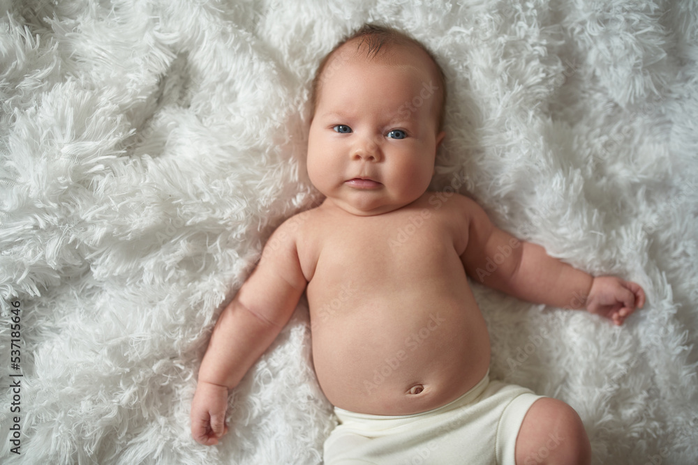A newborn baby lying on a fluffy blanket A newborn baby lying on a fluffy blanket