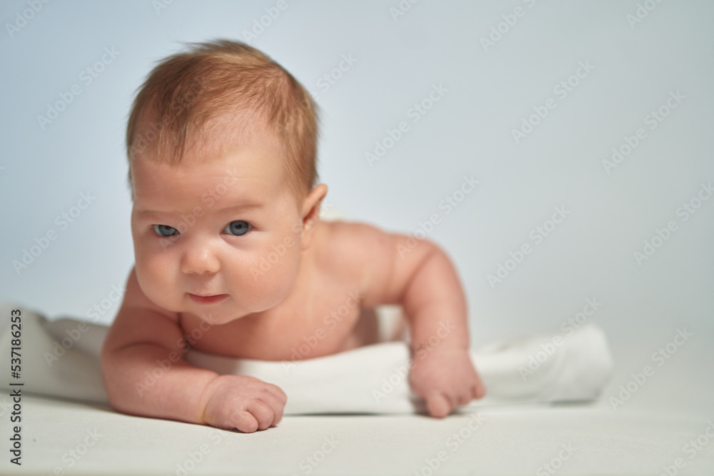 Close-up portrait of a newborn on a light background Close-up portrait of a newborn on a light background