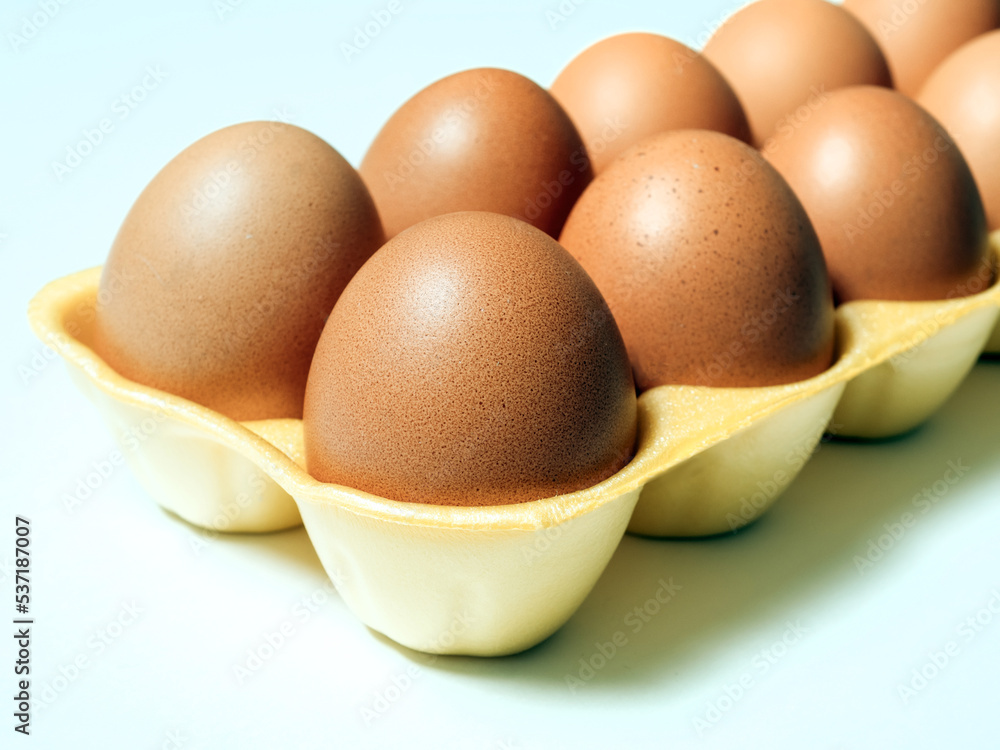 Eggs in the expanded polystyrene container box isolated on white background. Plastic trash. Close-up, selective focus Eggs in the expanded polystyrene container box isolated on white background. Plastic trash. Close-up, selective focus
