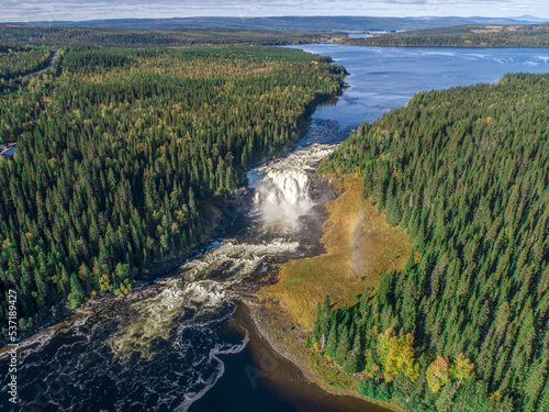 Aerial view famous waterfall Tannforsen northern Sweden, with a rainbow in the mist and rapid flowing cascades of water photo