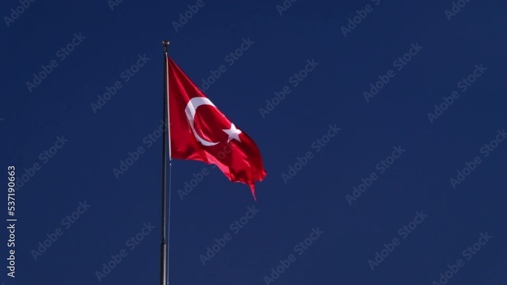 The Turkish flag fluttering in the wind in Kemer at evening, Turkey The Turkish flag fluttering in the wind in Kemer at evening, Turkey